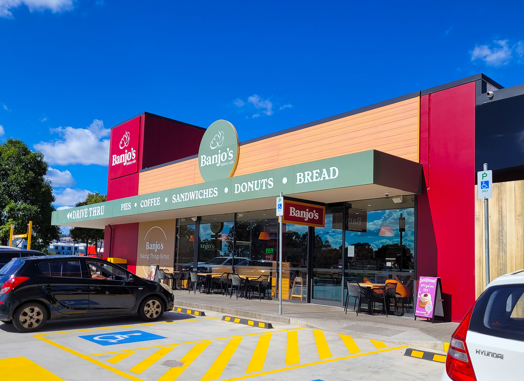 Hospitality Building, with red, green and timber colours throughout, the front carpark is on display.