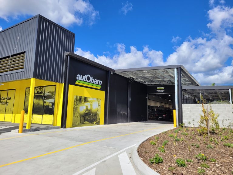 Industrial Buildings, Warehouse, retail buildings, Exterior Image of Autobarn Black & Yellow Colours shown, with advertising on display.