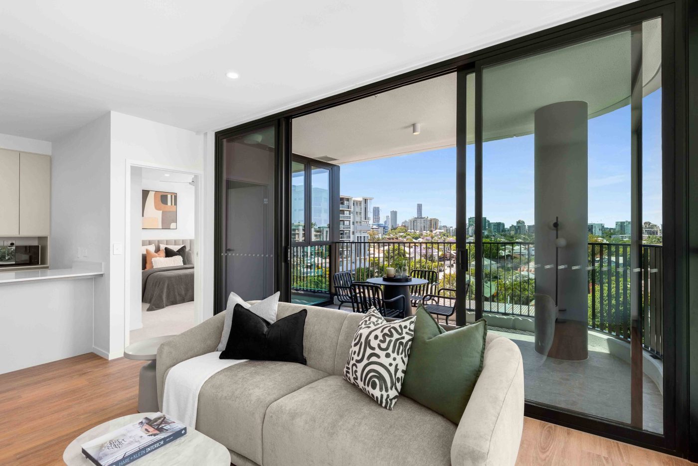 Interior Image of Story House apartment displaying wooden floors, balcony with the view of suburbia Brisbane.